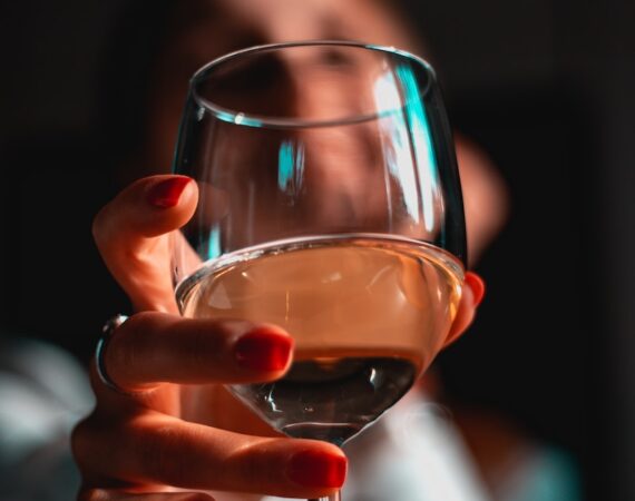 person holding clear wine glass
