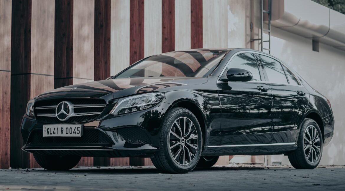 black porsche 911 parked in front of brown wooden wall